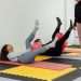 a group of people doing exercises in a gym