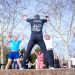 Group exercise session in a sunny Istanbul park led by a fitness coach outdoors.
